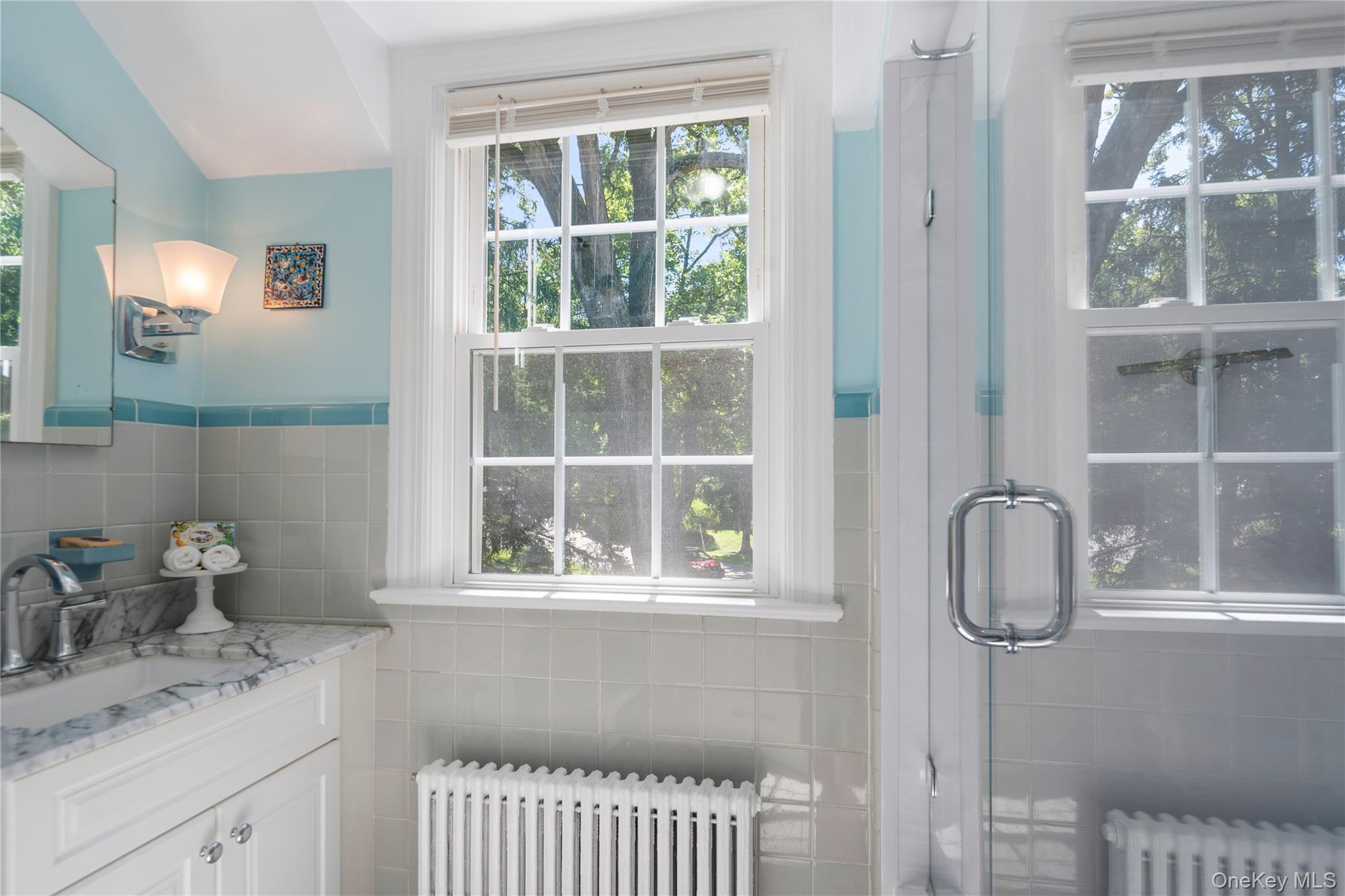611 Decatur Avenue Peekskill, NY 10566 - Photo 36 of 50 Renovated hall bath with glass shower w deep soaking tub, granite-top vanity, and unique decorative tiles.