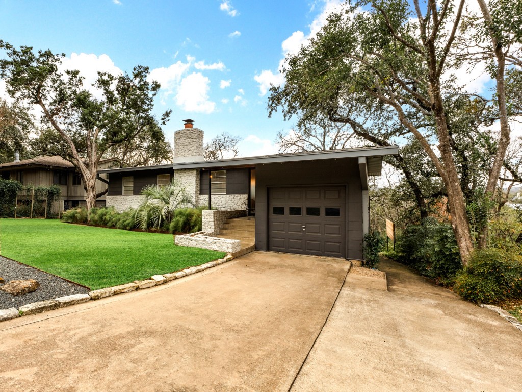 408 Brady Lane Austin, TX 78746 - Photo 1 of 1 a front view of a house with a garden and trees