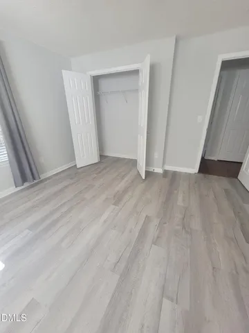 a view of an empty room and wooden floor