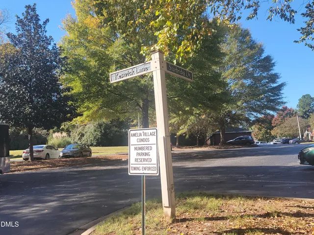 a street sign on a sidewalk next to a road