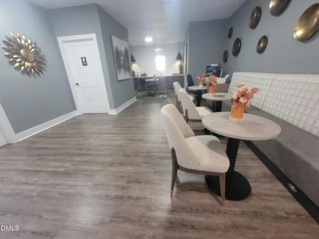 a view of a room with furniture and wooden floor