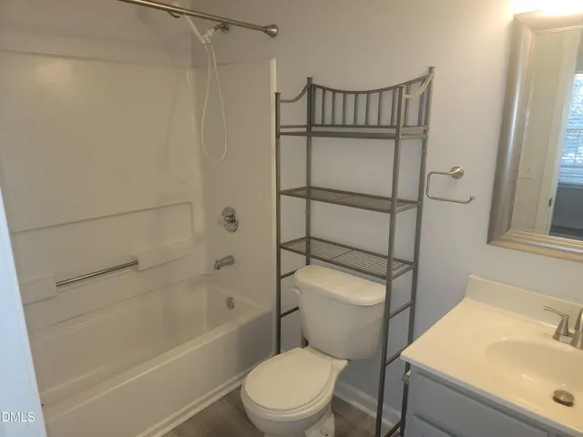 a bathroom with a toilet and a bathtub