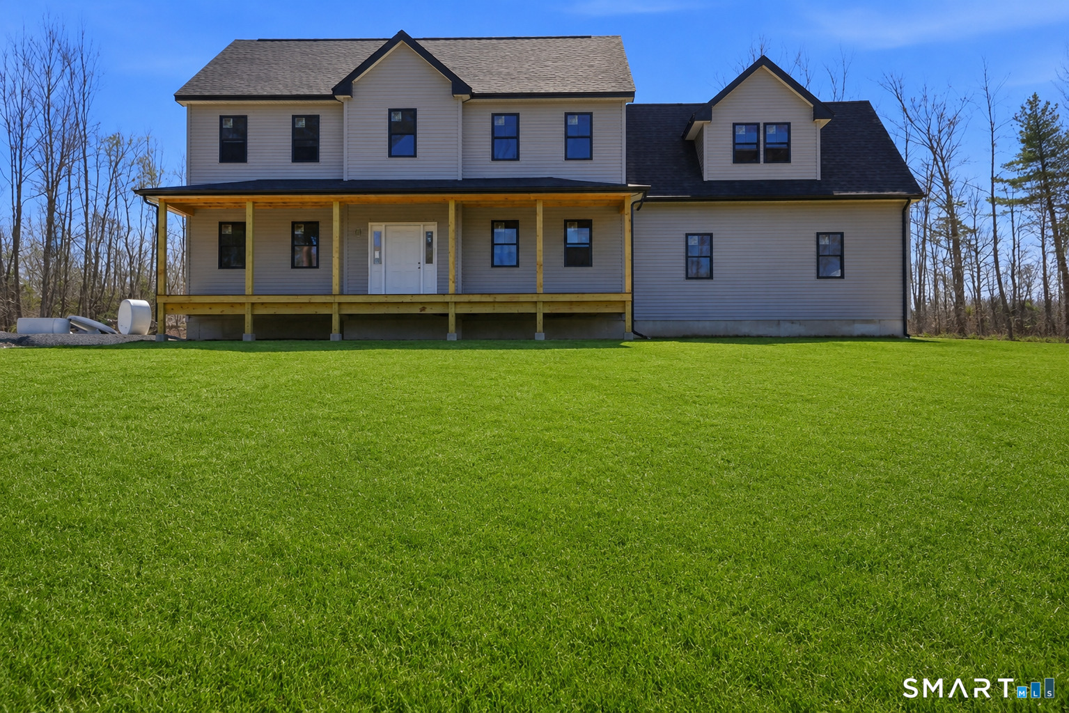 a view of a big house with a big yard and large trees