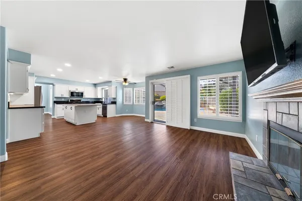 a view of a kitchen with wooden floor and a kitchen
