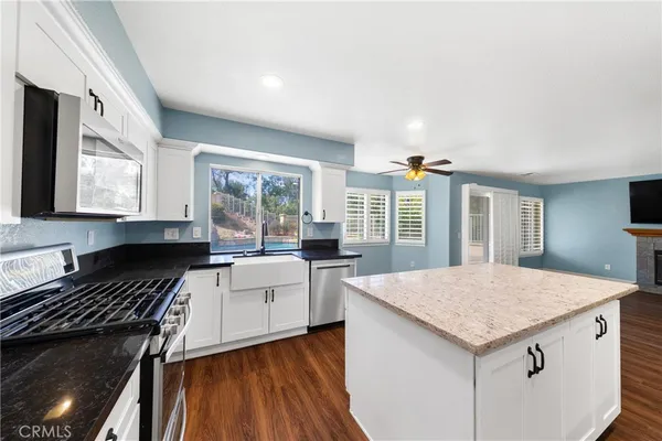a kitchen that has a sink and a stove in it