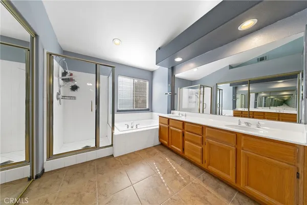 a large bathroom with a large tub and sink