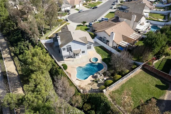 an aerial view of a house with a yard basket ball court and outdoor seating