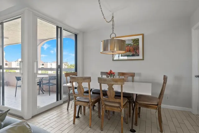 a view of a dining room with furniture wooden floor and a chandelier