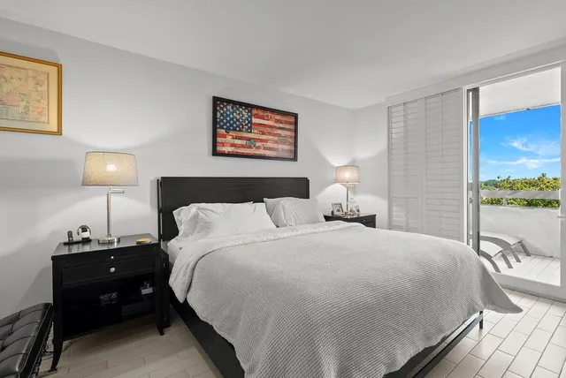 a bedroom with a bed and a lamp