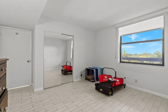 a bedroom with furniture and a potted plant