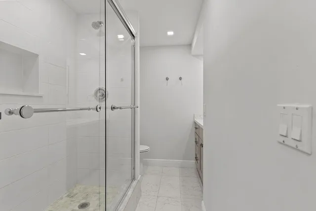 a bathroom with a shower and a glass door
