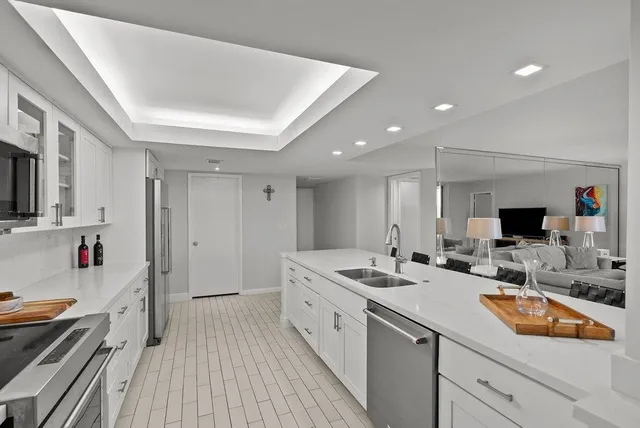 a kitchen with sink stove and refrigerator