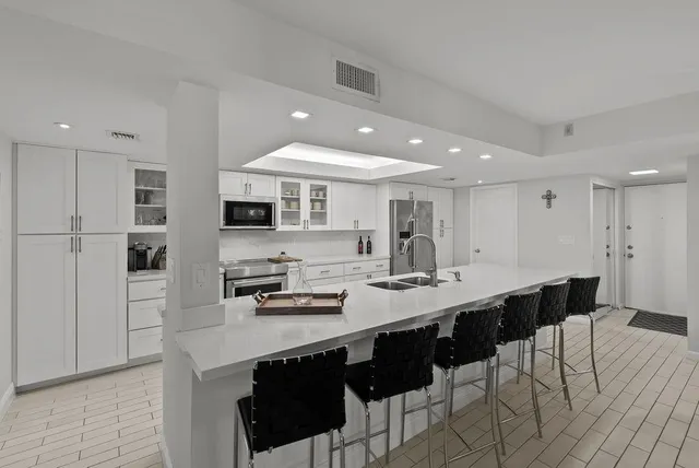 a kitchen with stainless steel appliances kitchen island granite countertop a sink and cabinets
