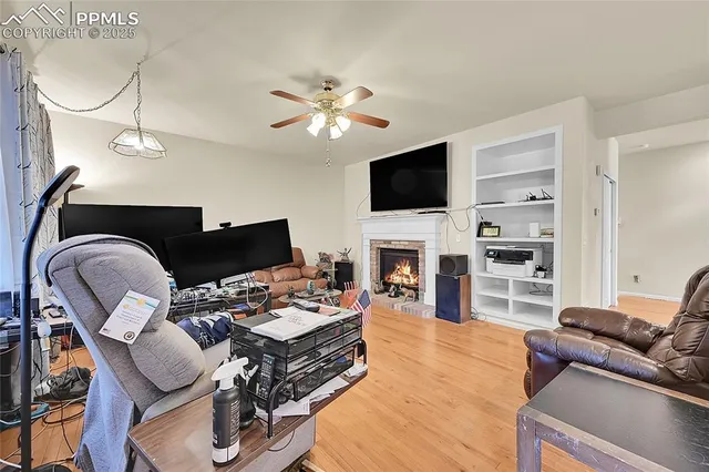 a living room with furniture a fireplace and a flat screen tv