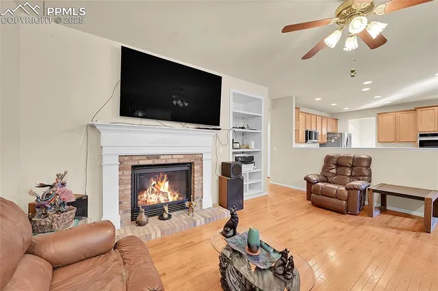 a living room with furniture fireplace and flat screen tv