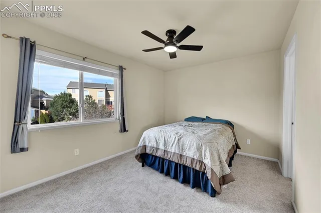 an empty room with windows and a ceiling fan