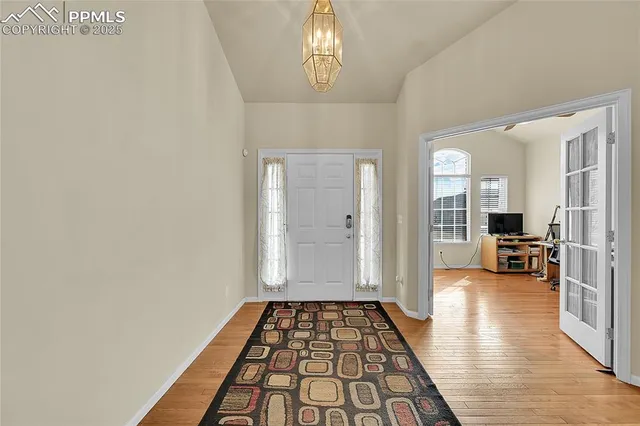 a view of a hallway view with wooden floor and furniture