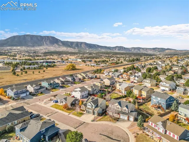 a aerial view of a house with a yard