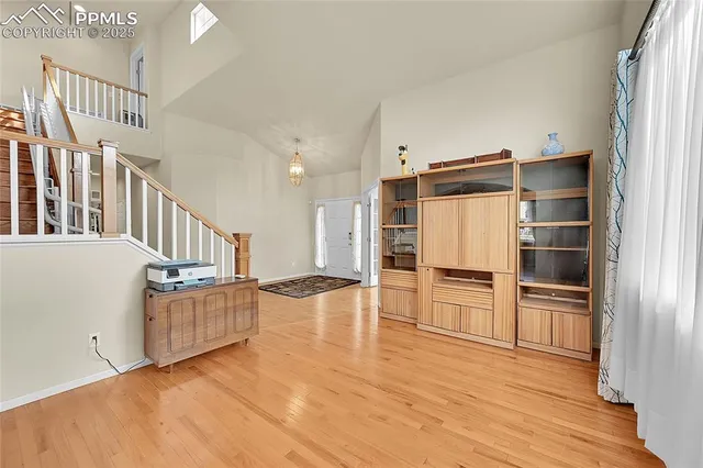 a kitchen with stainless steel appliances a refrigerator and wooden floor