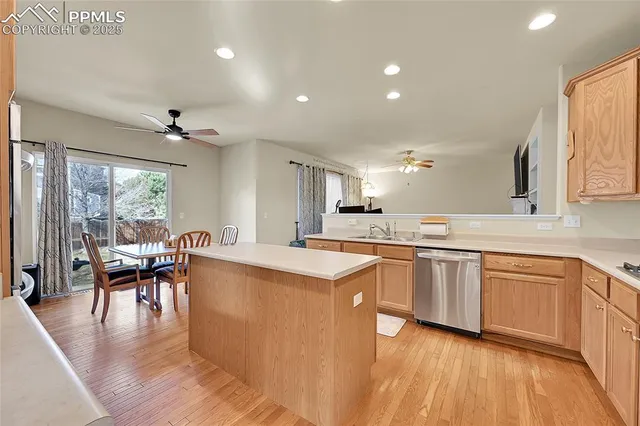 a large kitchen with cabinets table and chairs