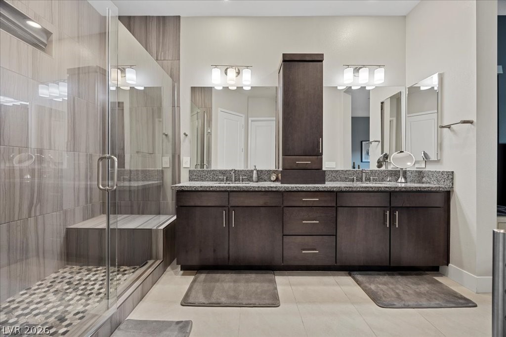 4262 Swift Street Las Vegas, NV 89135 - Photo 33 of 75 Bathroom featuring double vanity, a shower stall, and light tile patterned floors