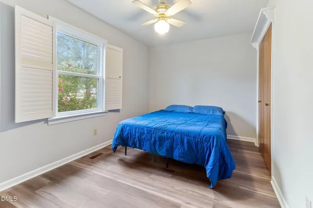 a bedroom with a bed and window