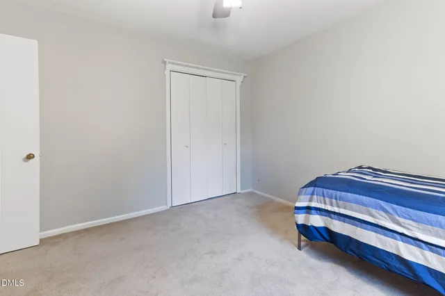 a room with a bed and a lamp on desk