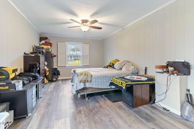 a bedroom with furniture and a wooden floor