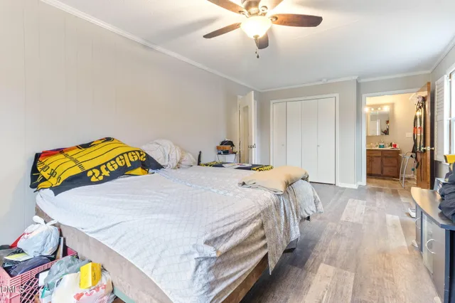 a bedroom with a bed and a chandelier