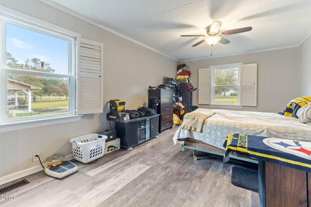 a bedroom with a bed and a chandelier