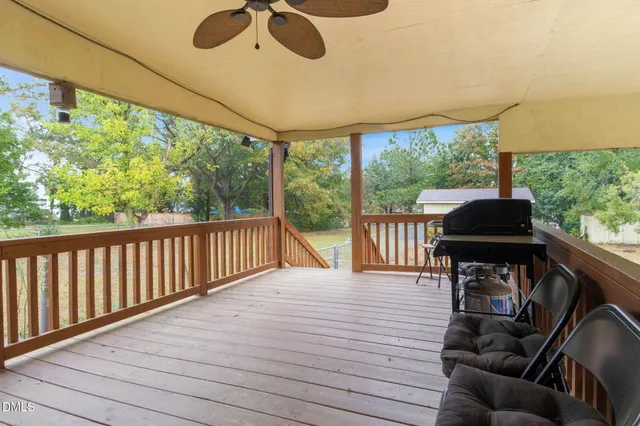 a view of a balcony with furniture and wooden floor
