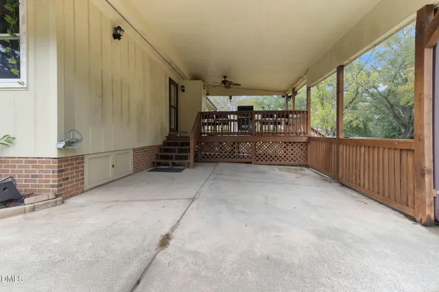 a view of a porch with wooden floor and iron fence