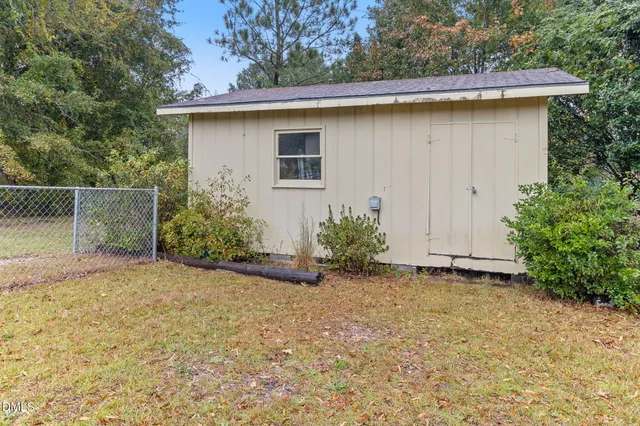 a backyard of a house with plants and trees