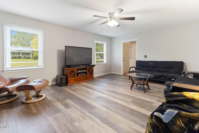 a living room with furniture and a flat screen tv