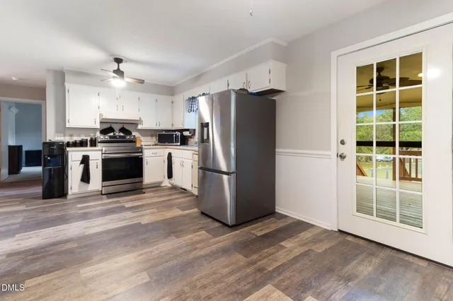 a kitchen with stainless steel appliances granite countertop a refrigerator a stove a sink and a microwave