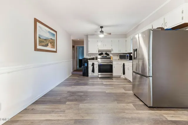 a kitchen with stainless steel appliances a refrigerator sink and stove