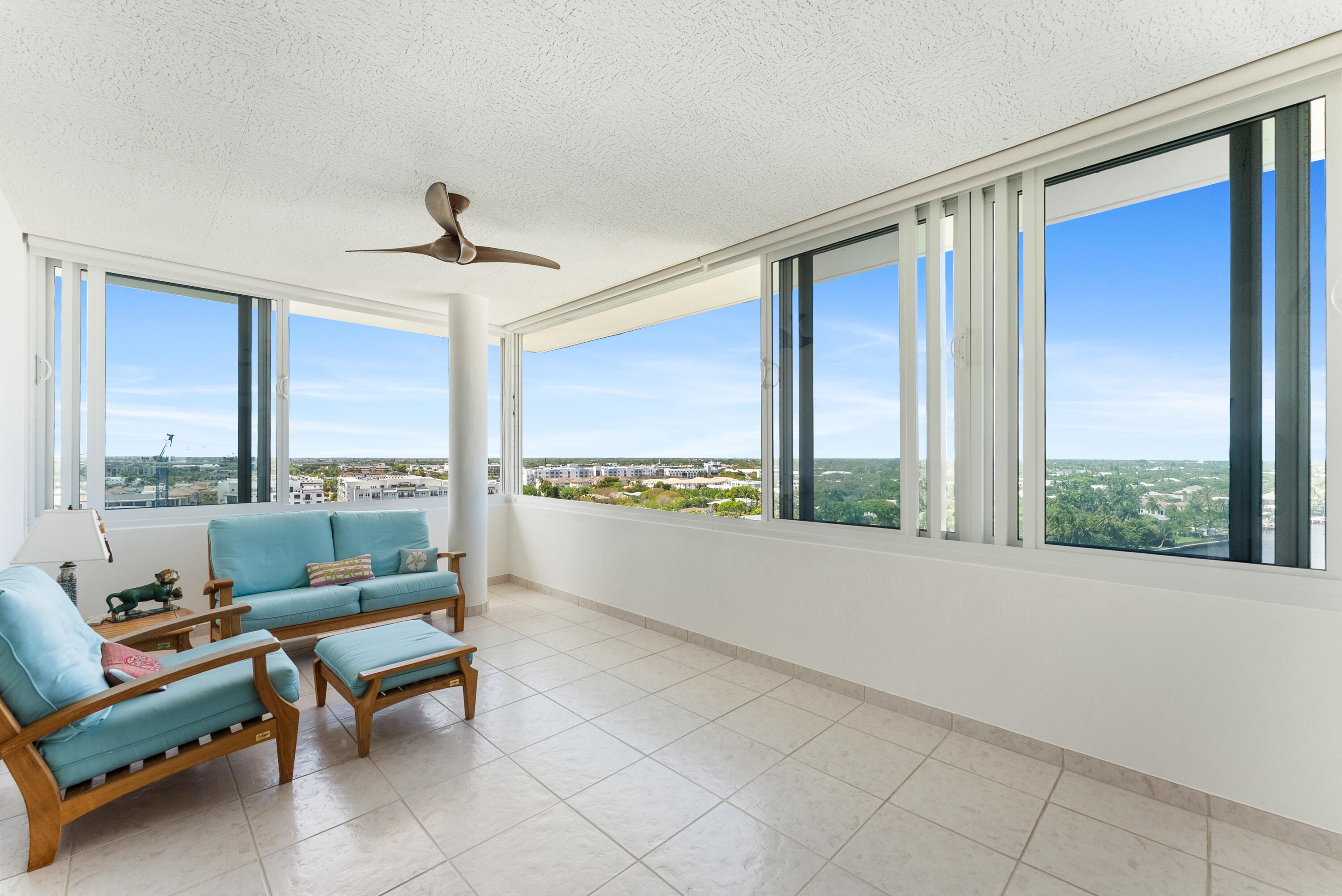 50 E Road, Unit 12A Delray Beach, FL 33483 - Photo 14 of 47 a living room with furniture and a floor to ceiling window