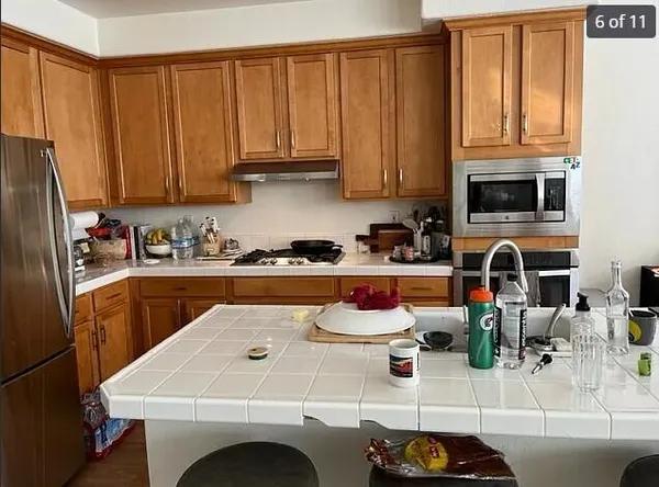 a kitchen with a sink a stove and cabinets