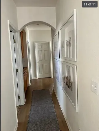 a hallway with wooden floor windows
