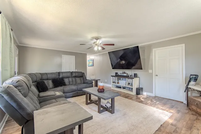 a living room with furniture and a flat screen tv