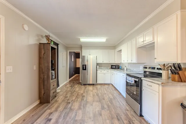 a kitchen with stainless steel appliances a refrigerator sink and cabinets