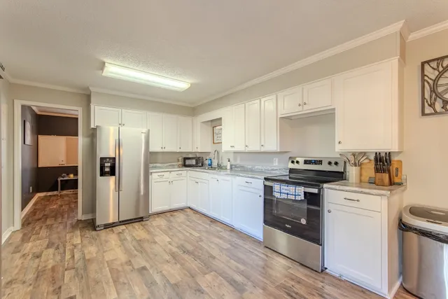 a kitchen with stainless steel appliances granite countertop a stove and a refrigerator