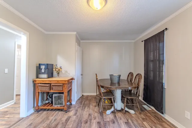 a dining room with furniture and wooden floor