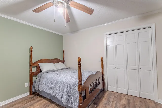 a bedroom with a bed and a chandelier