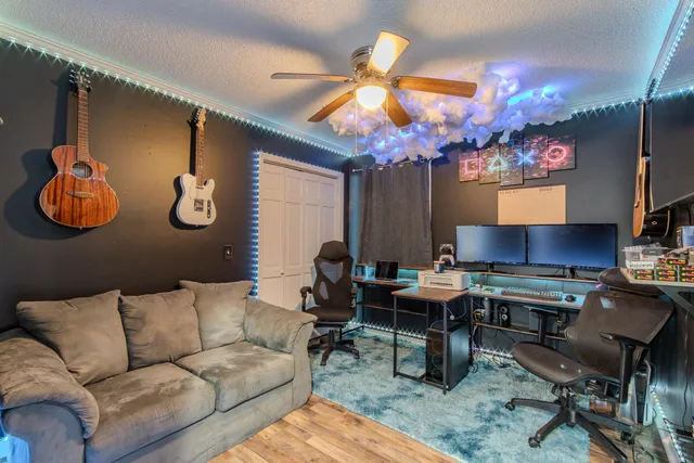 a living room with furniture a chandelier and a dining table