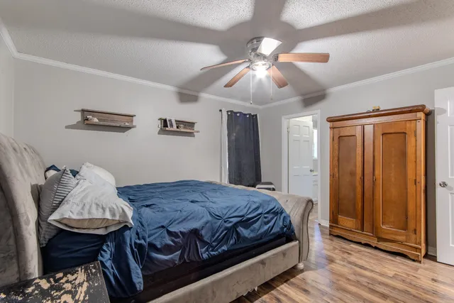 a bedroom with a bed and a chandelier