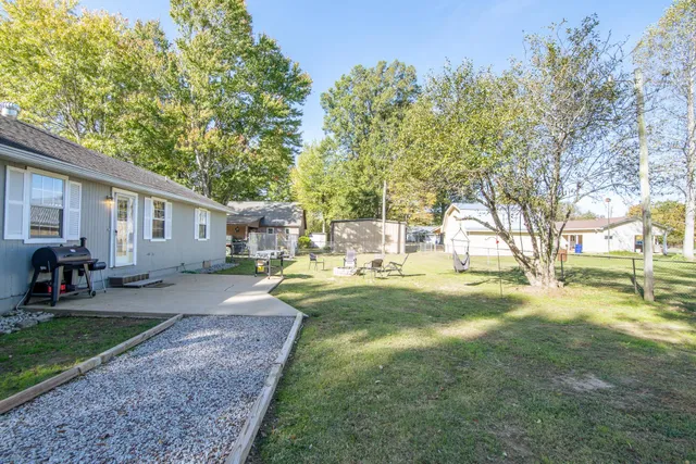 a view of a yard with a house and a tree