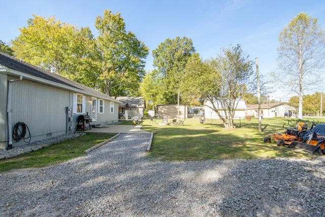 a view of a backyard with large trees