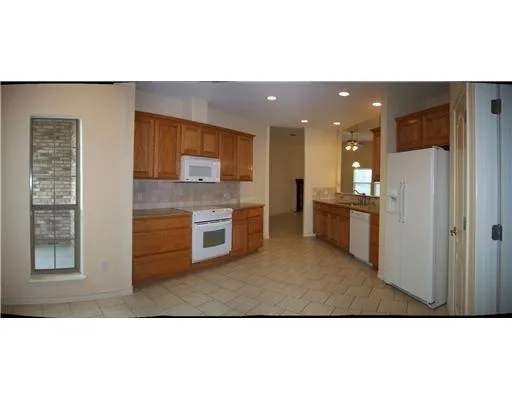 a open kitchen with refrigerator stove and kitchen island