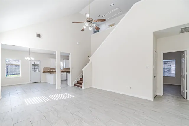 a view of a livingroom with a ceiling fan and entryway